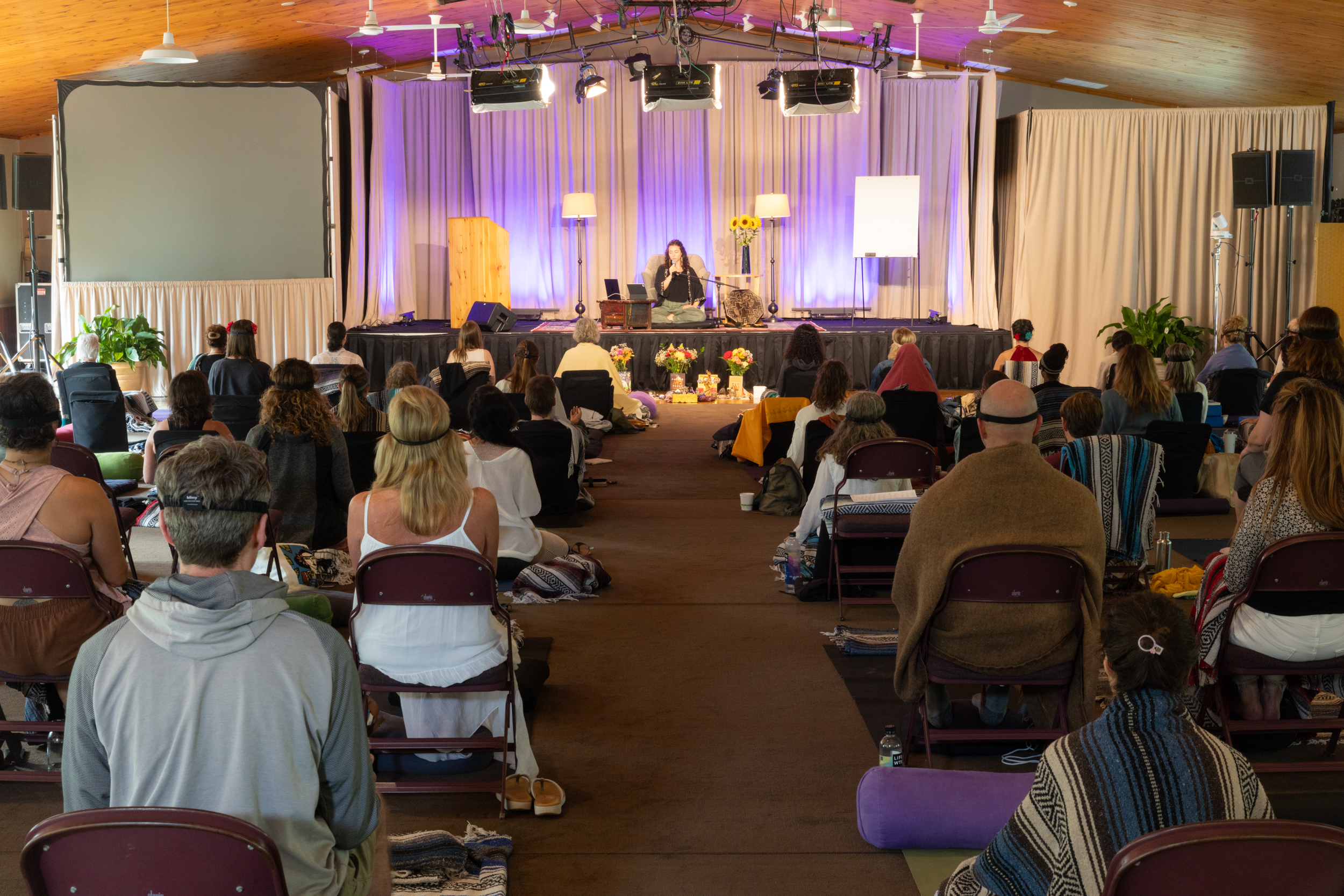 Eluña Noelle teaching on stage at Omega Institute, with participants gathered before her